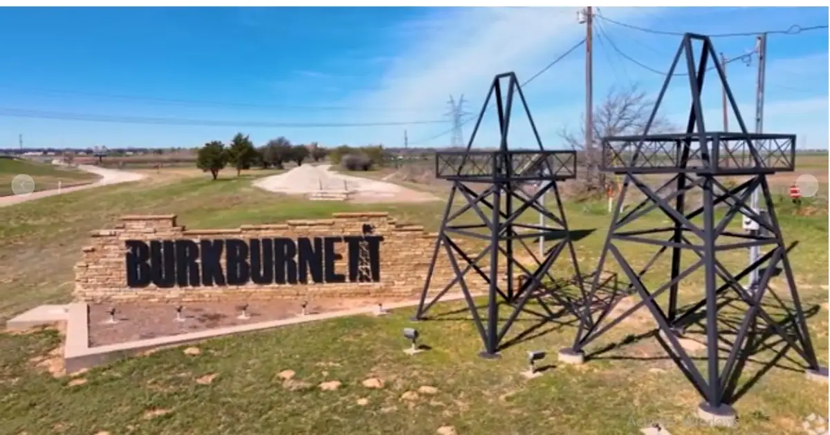 Areas We Serve 4 Stone welcome sign for Burkburnett Texas featuring twin metal oil derrick monuments on green landscape