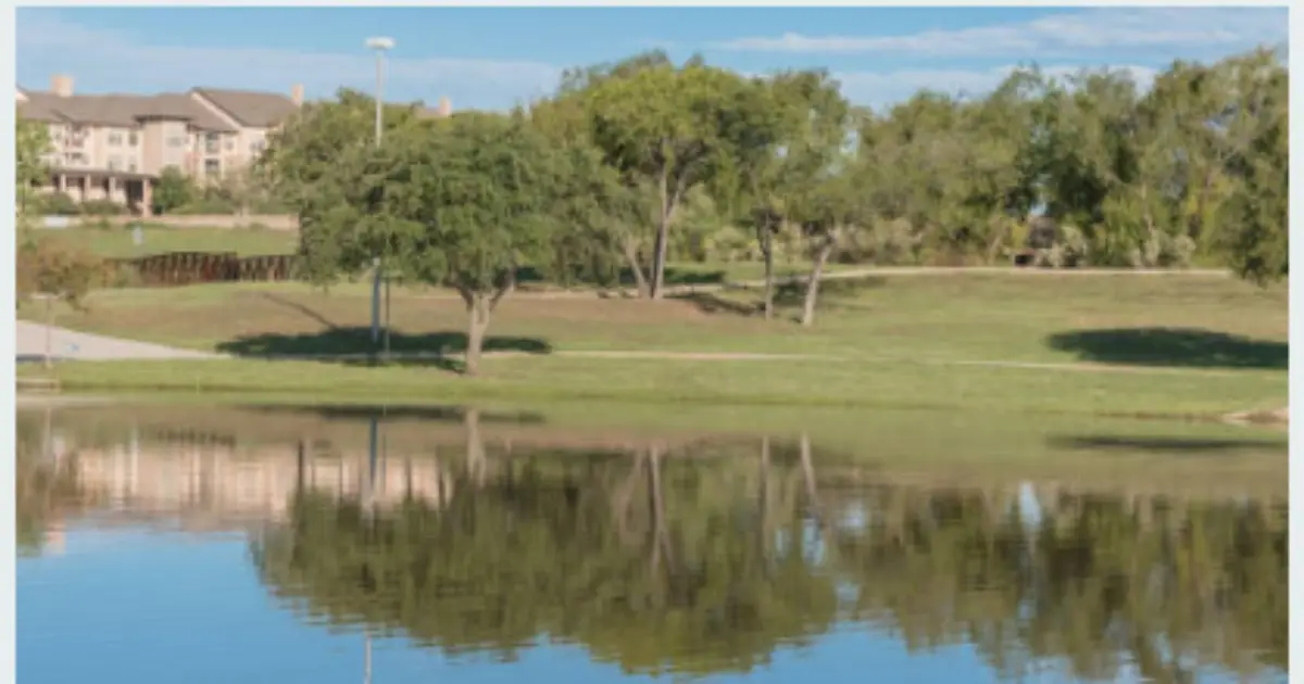 Areas We Serve 7 Scenic lake and green park area with tree reflections in Iowa Park Texas